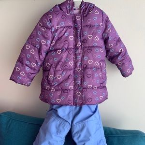 Ski jacket in purple and blue ski pants